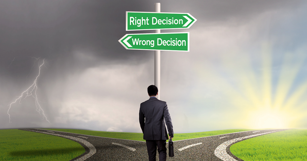 This is an image of a person standing at crossroads and on the left-hand-side lies the road to wrong decision and on the right-hand-side lies the road to right decision
